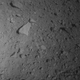 A view of Ryugu’s surface, with the shadow of Hayabusa 2 seen at far left.